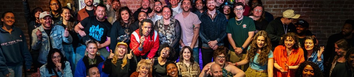Comics and staff packed together against the brick wall of the Mic Drop stage after a show